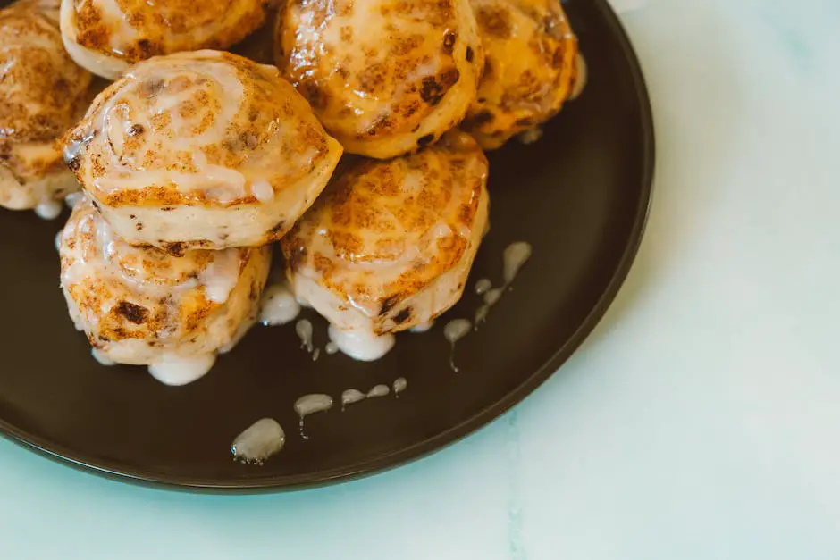 Picture of Browned Butter Cinnamon Rolls after they have been baked and have a golden crust. Icing is drizzled over them.